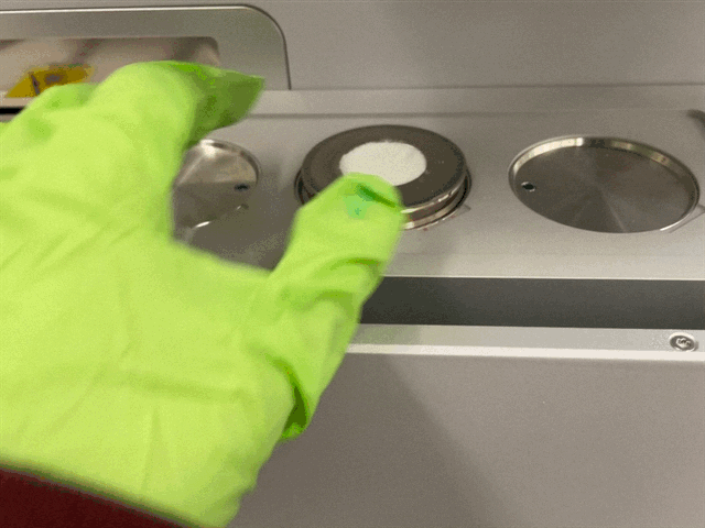 Placing a prepared sample in the sample changer.